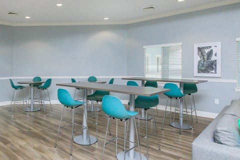 A dining room with a long table and chairs.