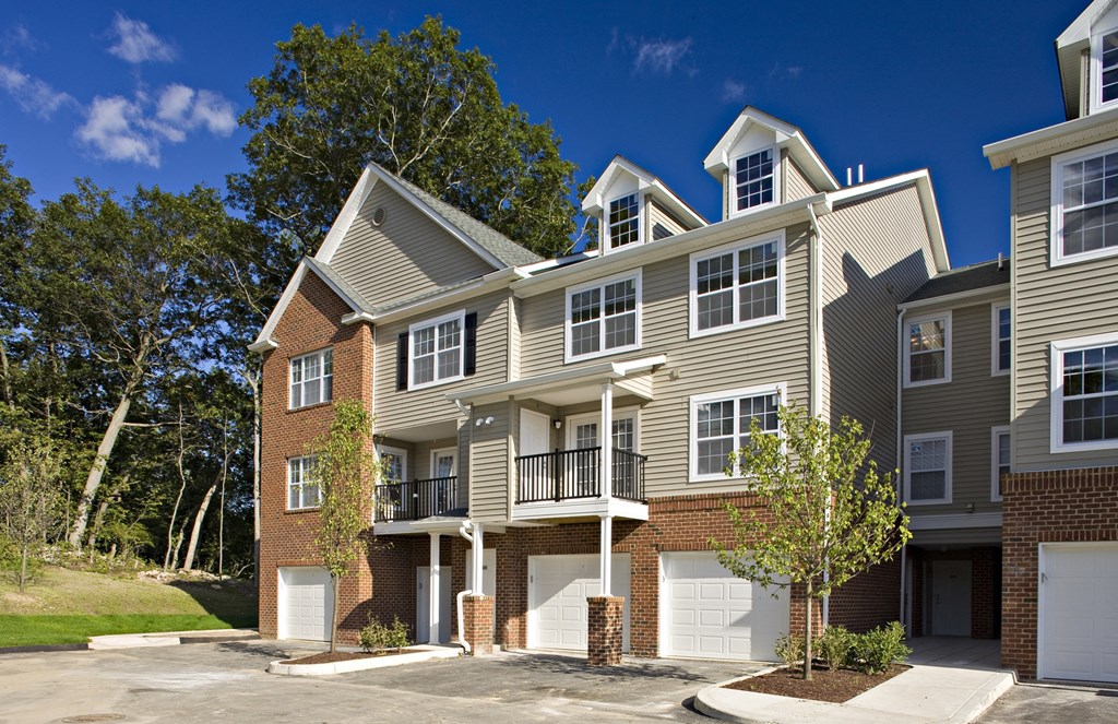 a row of town houses with white doors and balconies