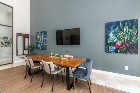 A dining room with a wooden table and chairs.