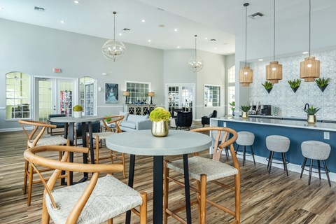 A dining area with a round table and chairs.