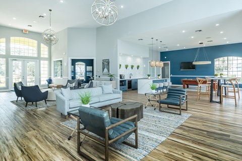 A modern living room with a white sofa set and a wooden coffee table.