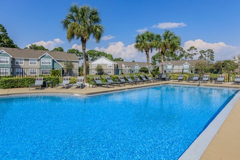 A swimming pool in front of a residential area.