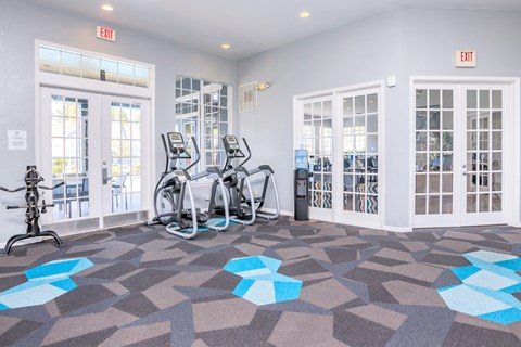 A gym with exercise bikes and a treadmill.