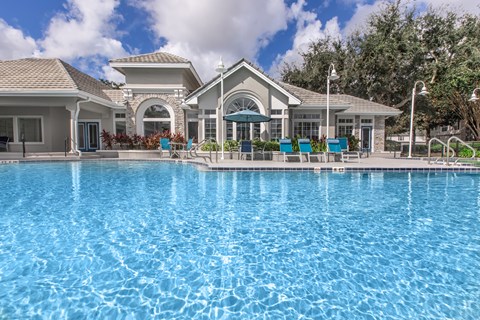 A large swimming pool in front of a building.