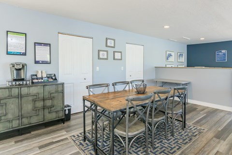 A dining room with a wooden table and chairs.
