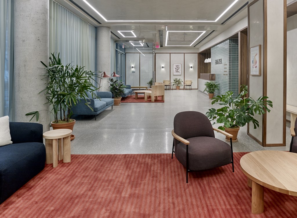 The lobby at The Hazel greets residents and guests with a sophisticated and contemporary design, featuring sleek furnishings, stylish decor, and a welcoming ambiance, setting the stage for an elevated living experience from the moment they step through the doors.