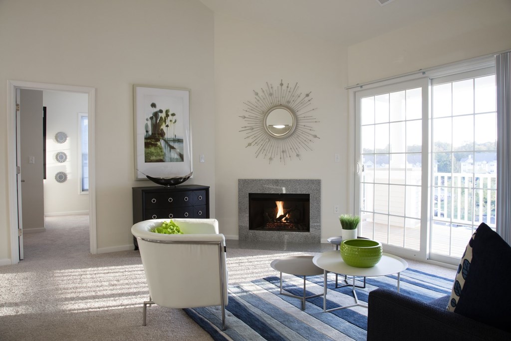 A living room with a fireplace and a chair.