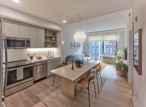 A modern kitchen with a dining table and chairs.