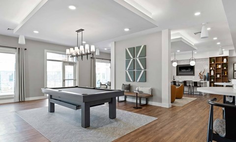 A modern living room with a pool table and a television.
