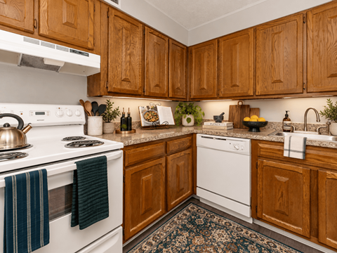 A kitchen with wooden cabinets and white appliances.