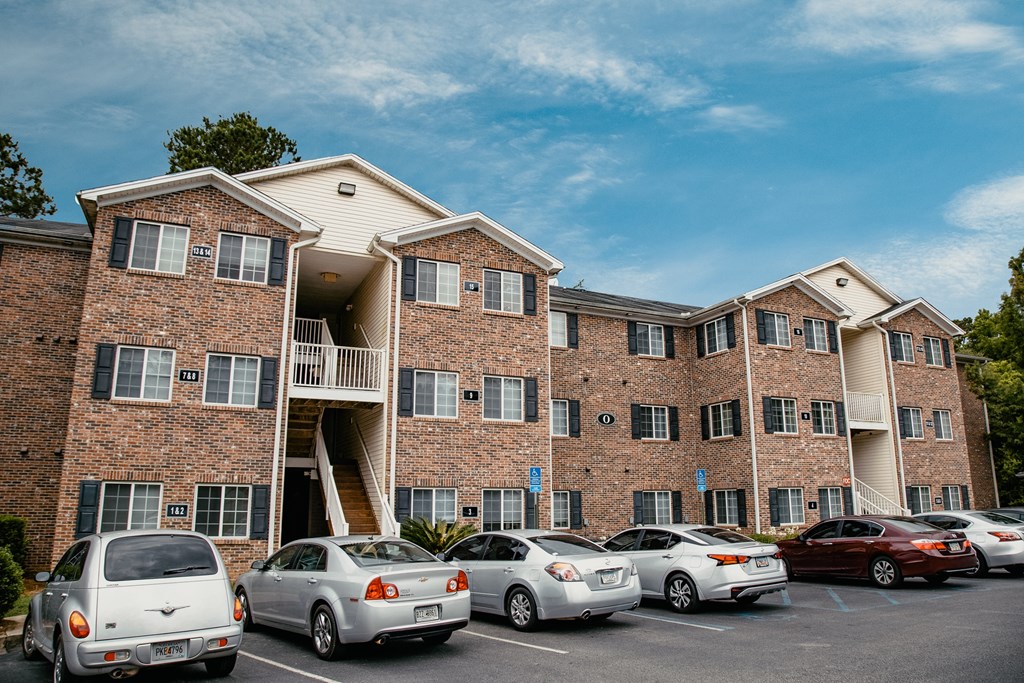 an apartment building with cars parked in front of it