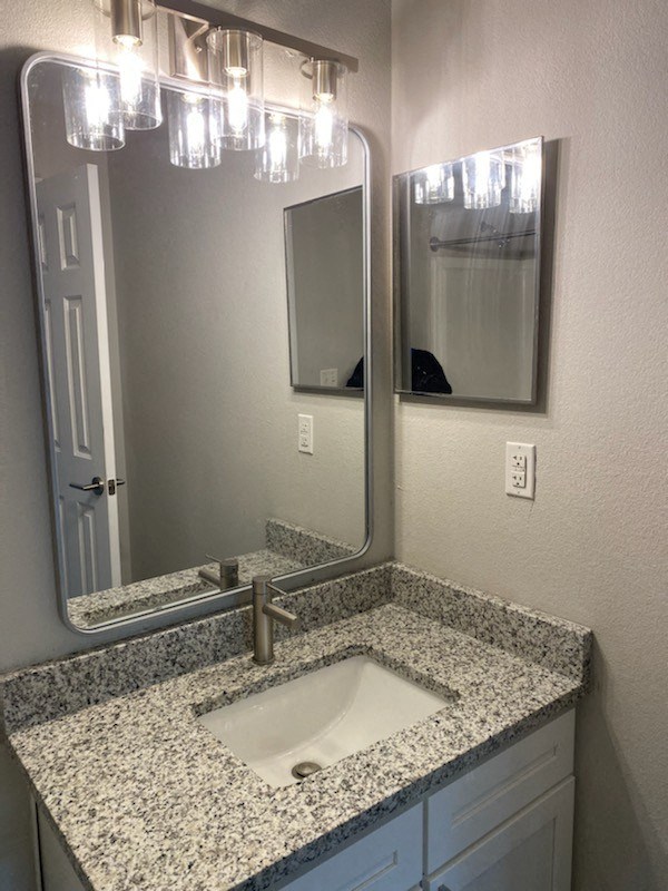a bathroom with a sink and a mirror