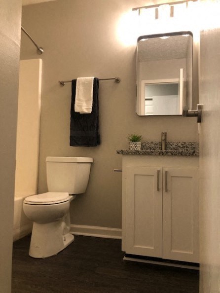 a bathroom with a toilet and a sink and a mirror
