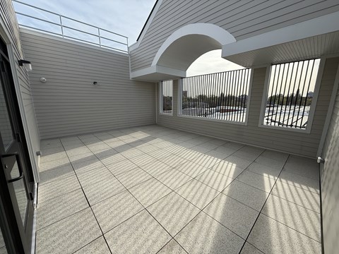 A sunny day at the balcony with a view of the beach.