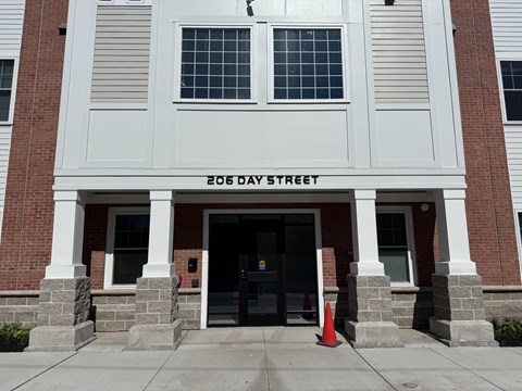 The front of a building with the words 206 Day Street written on it.