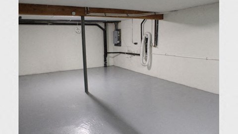 A white pipe runs along the wall in a room.