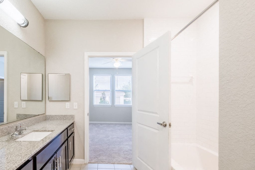 a bathroom with a shower and a sink and a mirror at Linden on the GreeneWay, Florida, 32824