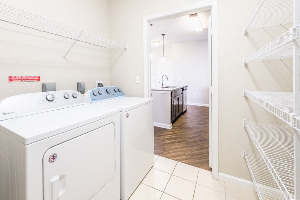 a washer and dryer in a laundry room with a closet at Linden on the GreeneWay, Florida, 32824