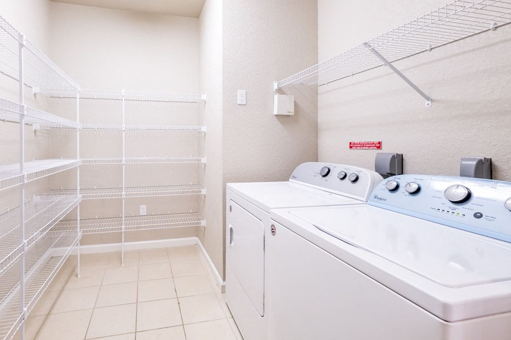 a washer and dryer in a laundry room with a closet at Linden on the GreeneWay, Florida