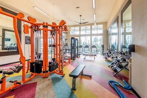 a gym with cardio machines and other equipment in the lobby of a building
