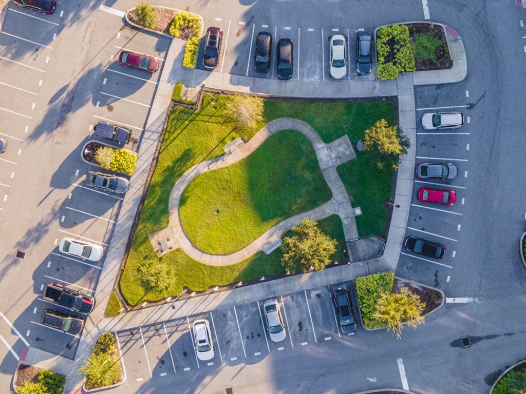 an aerial view of a parking lot with cars and grass  at Linden on the GreeneWay, Florida
