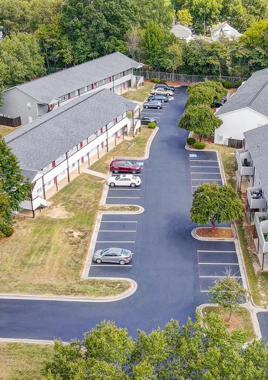 Aerial view of property with car parking lot at Ashford Place Apartments in Kannapolis, NC 28081