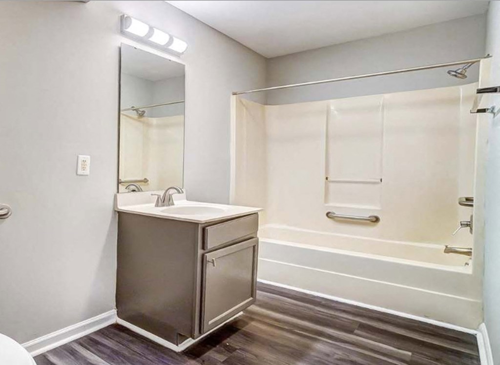 Bathroom with a sink and a shower and a mirror at Ashford Place Apartments in Kannapolis, NC 28081