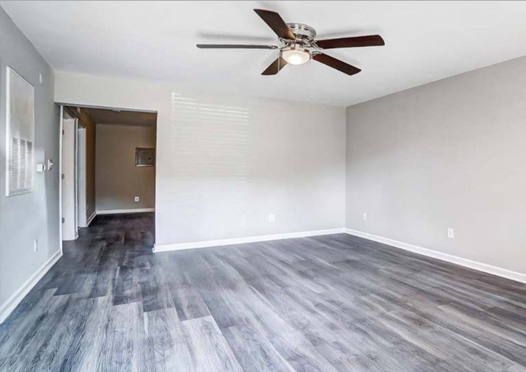 Living room with a ceiling fan at Ashford Place Apartments in Kannapolis, NC 28081