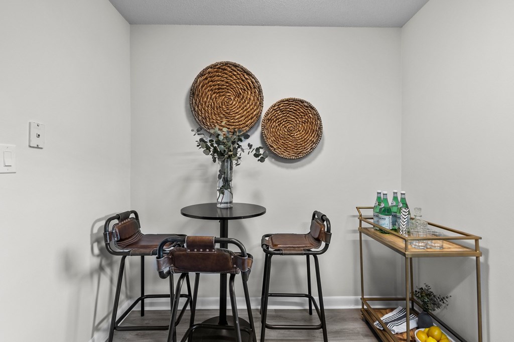 A white room with a round table and two chairs at West Oak Apartments, Wake Forest, North Carolina