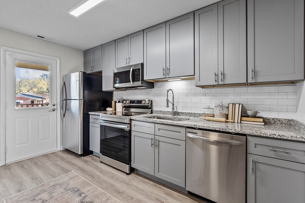 A kitchen with a refrigerator, oven, and microwave at West Oak Apartments, North Carolina 27587