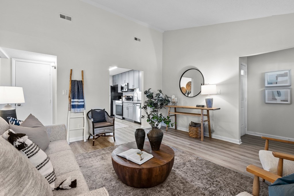 A living room with a grey couch and a wooden coffee table at West Oak Apartments, North Carolina 27587