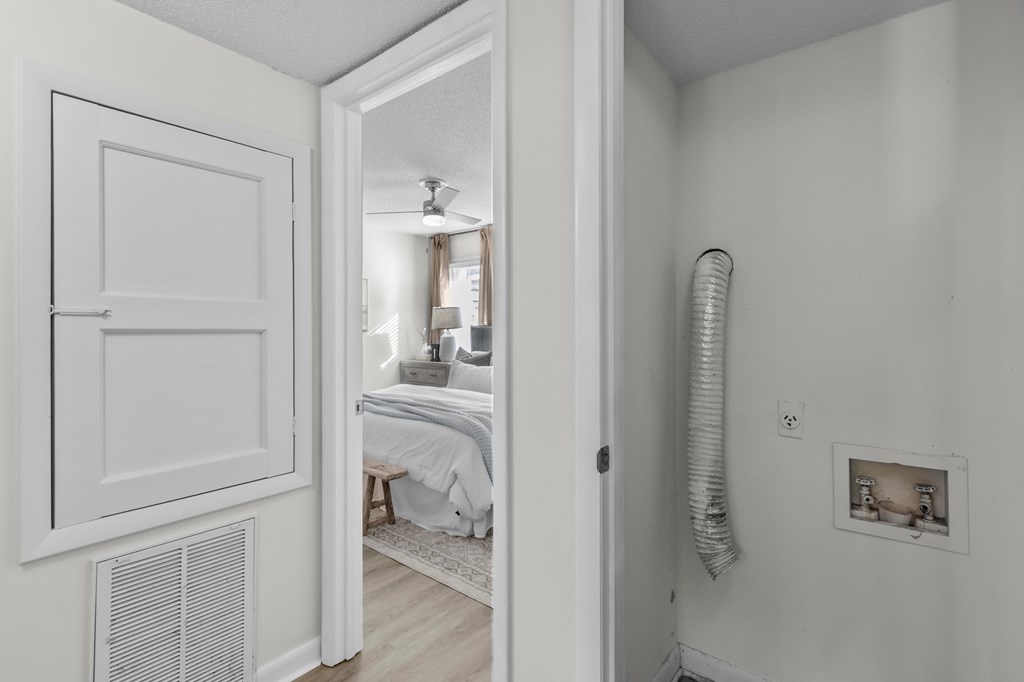 A white room with a bed and a window at West Oak Apartments, Wake Forest, NC