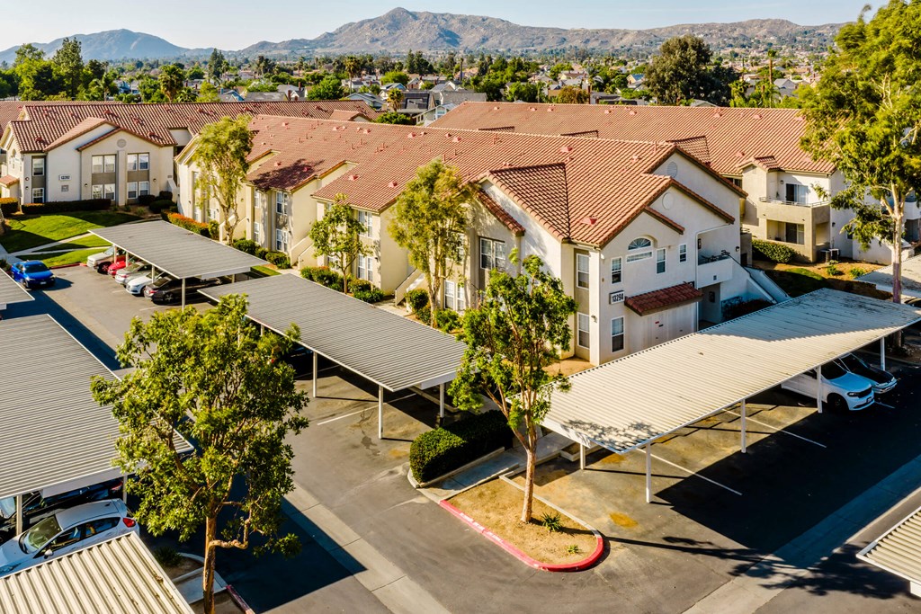 A large group of houses with a parking lot in front. at Legends at Rancho Belago, Moreno Valley, CA, 92553