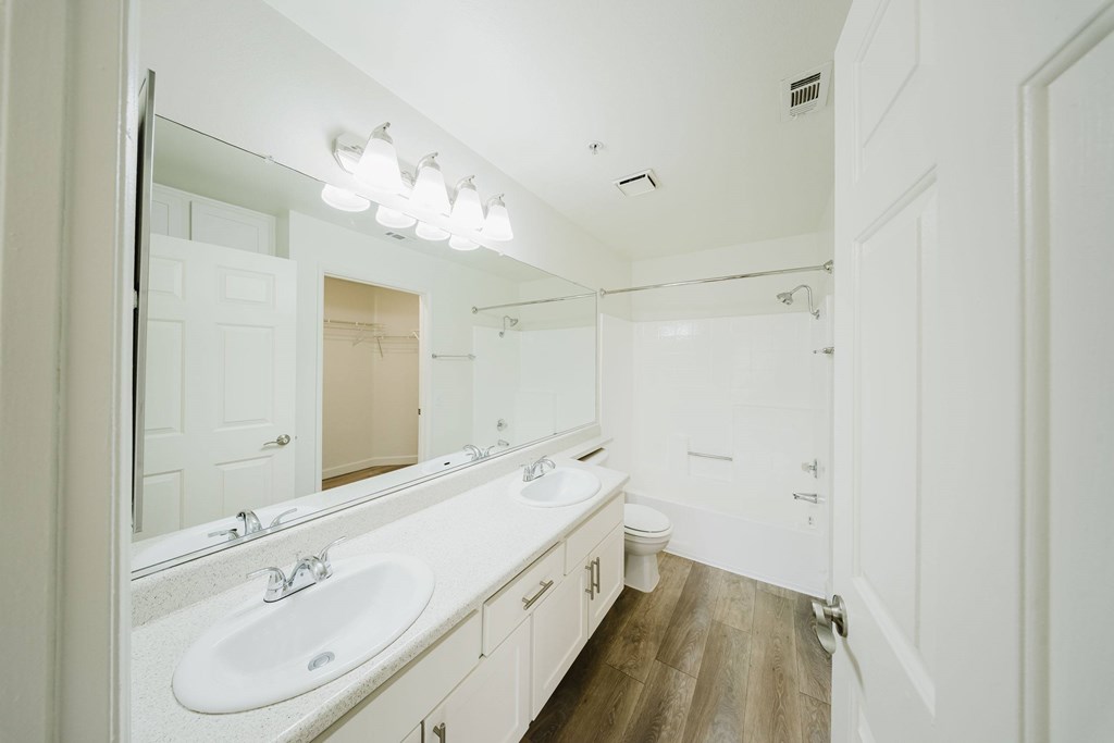 A bathroom with a white sink and mirror. at Legends at Rancho Belago, Moreno Valley, 92553