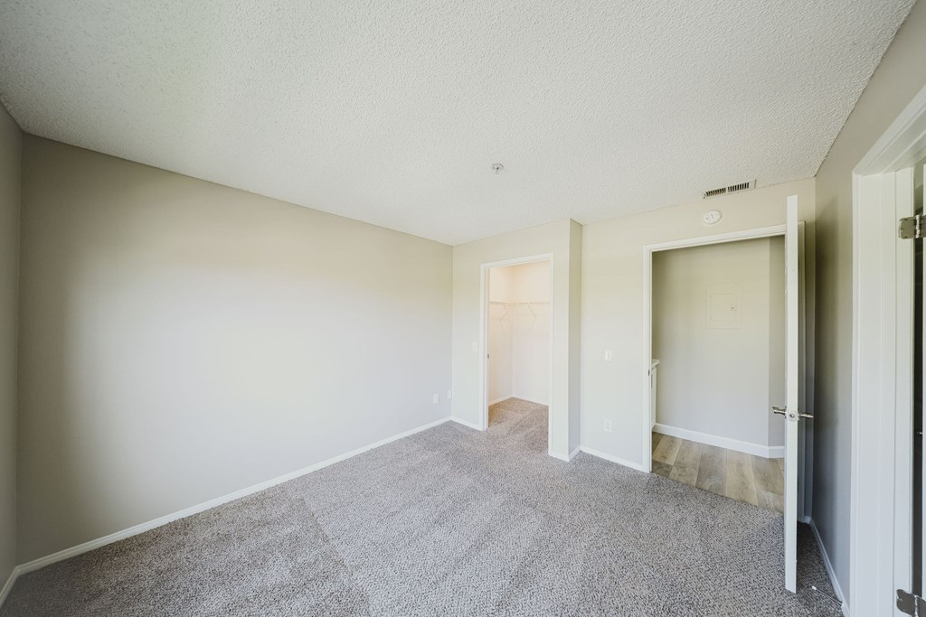 A room with a carpeted floor and white walls. at Legends at Rancho Belago, Moreno Valley