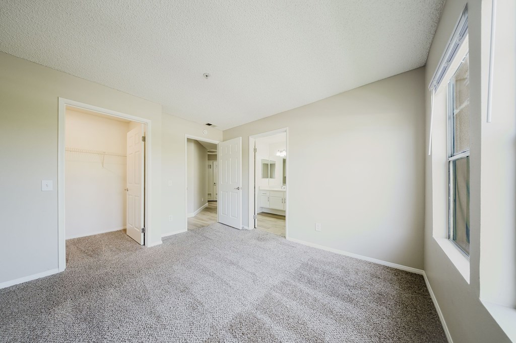 A spacious room with carpeted floor and white walls. at Legends at Rancho Belago, Moreno Valley, 92553