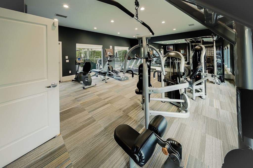 A gym with a variety of equipment including weights and cardio machines. at Legends at Rancho Belago, Moreno Valley, California