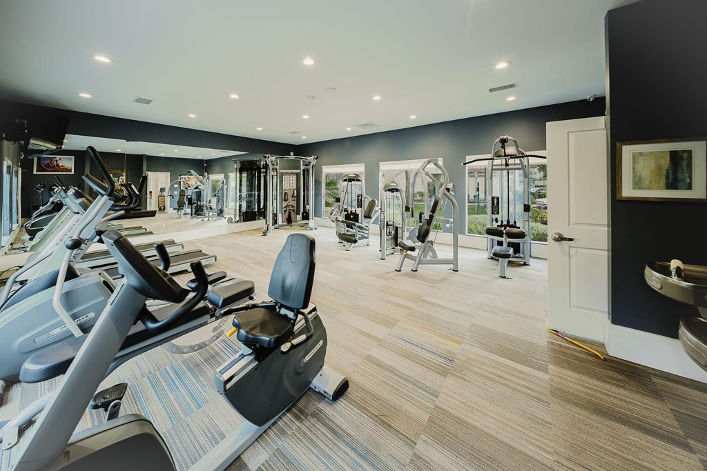 A gym with treadmills, elliptical machines, and other exercise equipment. at Legends at Rancho Belago, Moreno Valley
