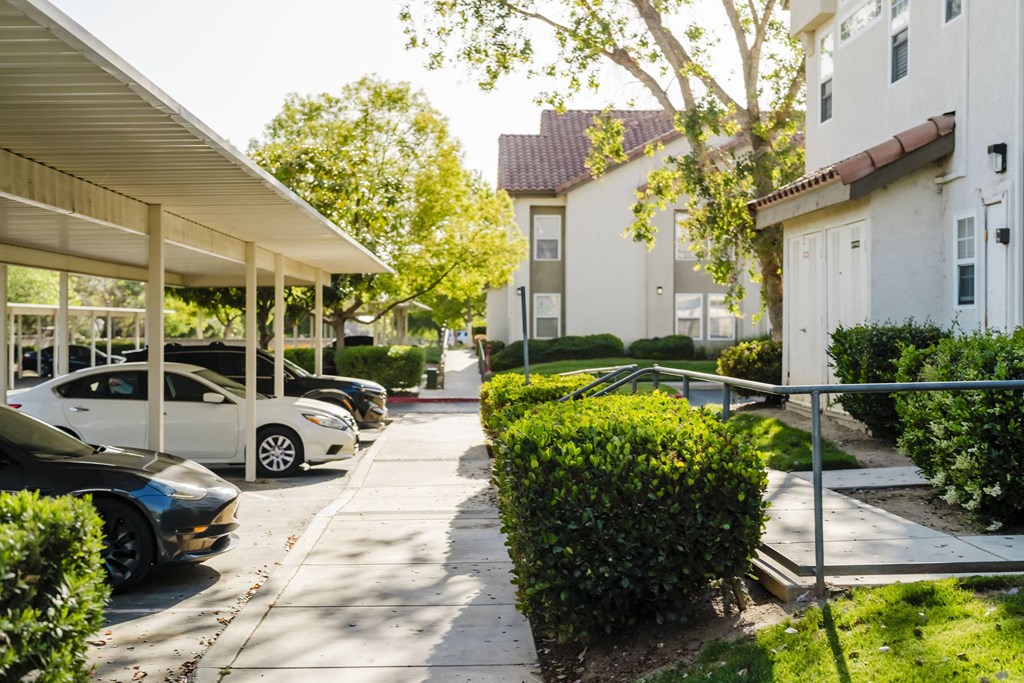 A row of parked cars in front of a building. at Legends at Rancho Belago, California