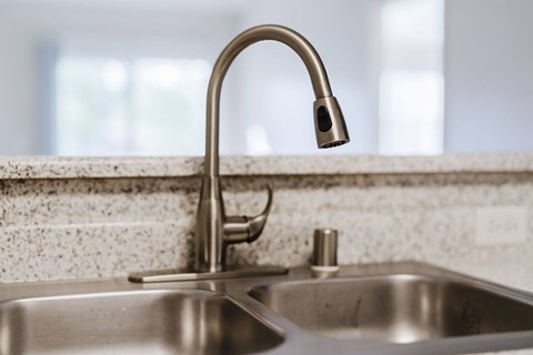 A kitchen sink with a chrome faucet. at Legends at Rancho Belago, Moreno Valley, California