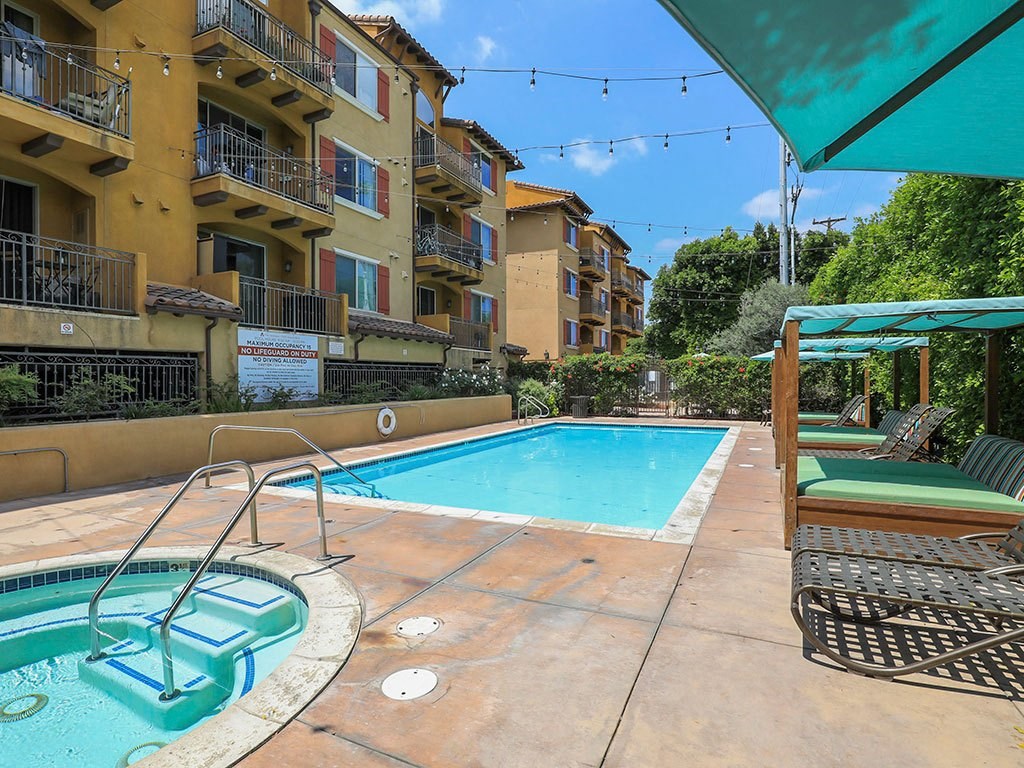 Swimming Pool with Cushioned Seating Areas at the verandas apartments near los angeles