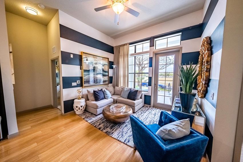 a living room with blue and white walls and a sliding glass door