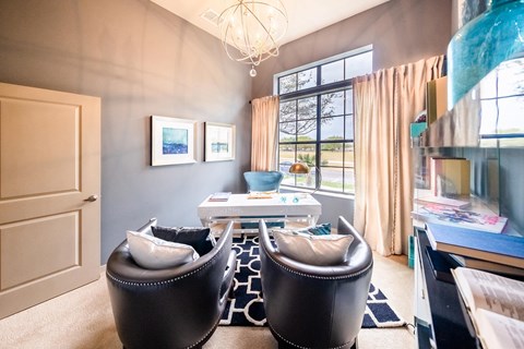 a living room with two chairs and a table and a window at Azul Baldwin Park, Orlando, 32814