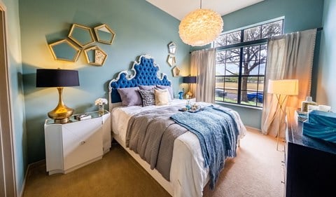 a blue and white bedroom with a bed and a window at Azul Baldwin Park, Orlando, Florida