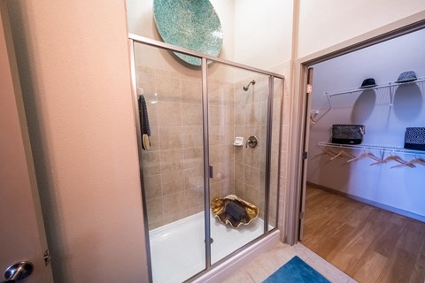 a shower with a glass door in a bathroom at Azul Baldwin Park, Florida