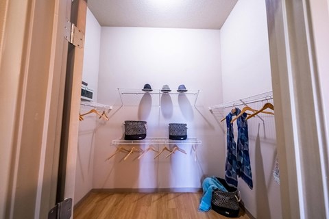 a walk in closet in a small room with clothes and shoes at Azul Baldwin Park, Orlando