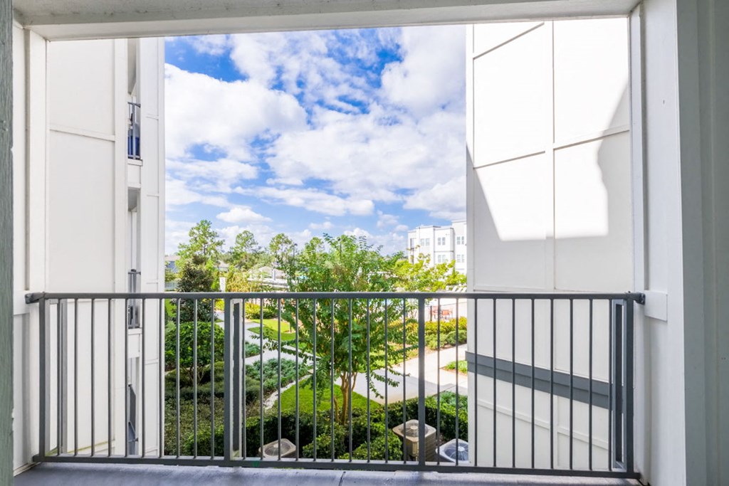 a balcony with a view of a building and trees at Linden on the GreeneWay, Orlando, Florida