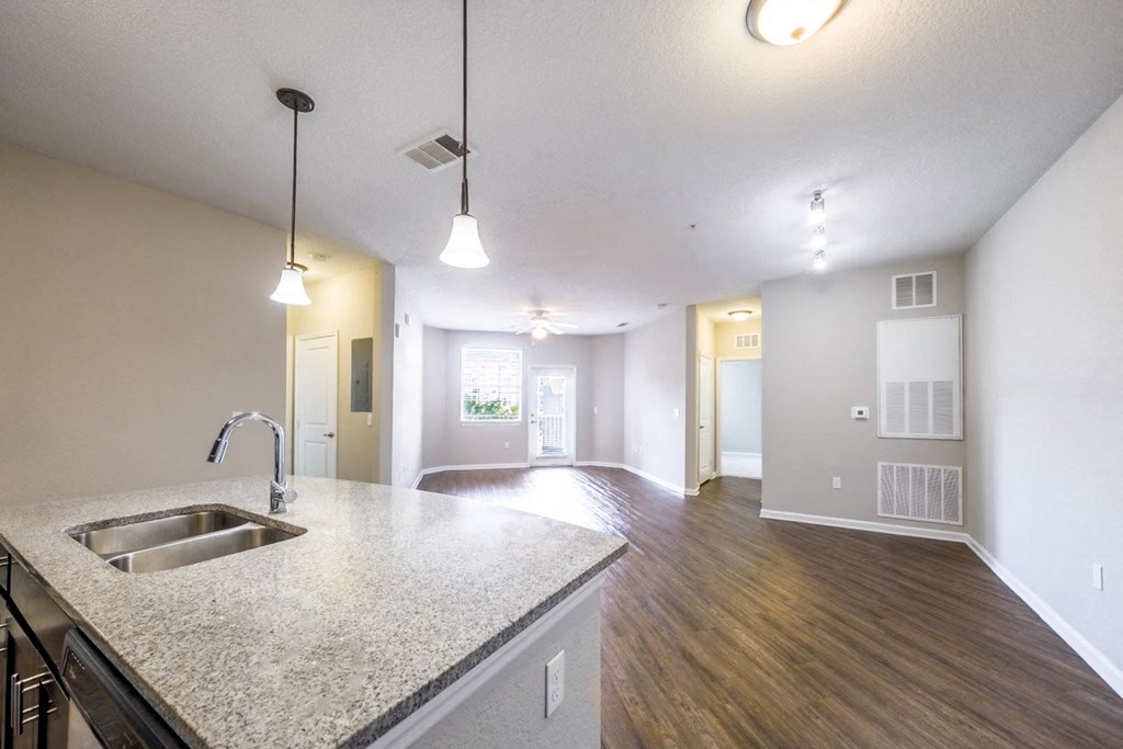 an empty living room and kitchen with a sink at Linden on the GreeneWay, Florida, 32824
