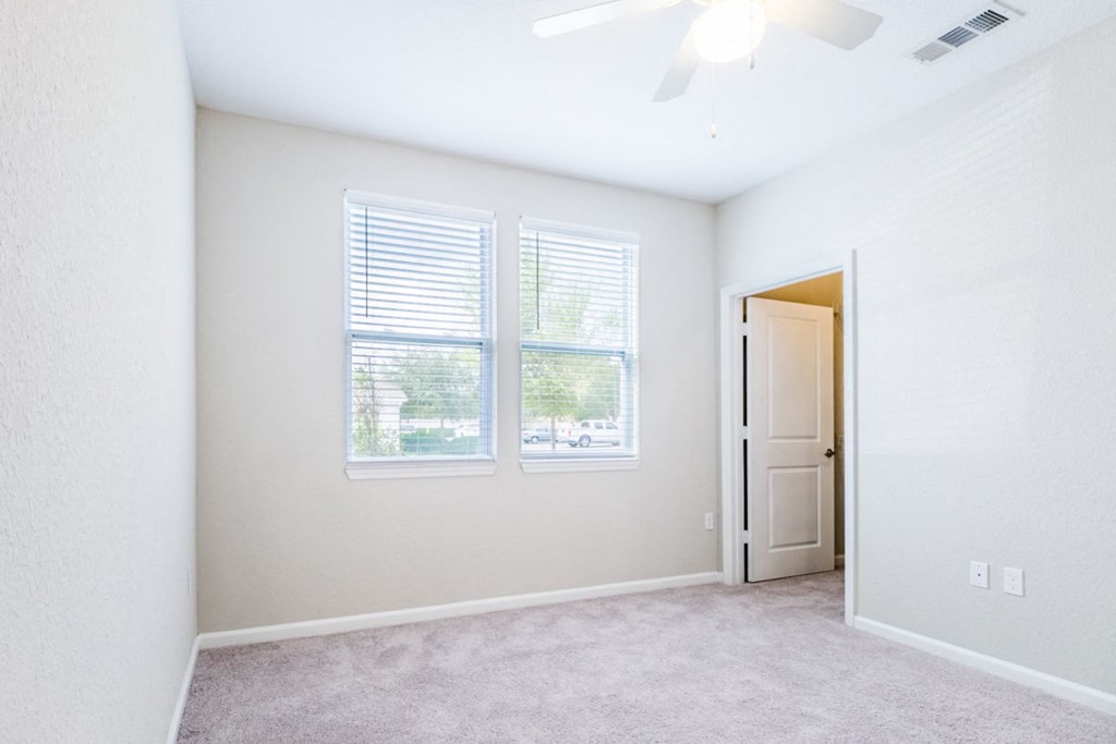 an empty living room with two windows and a door at Linden on the GreeneWay, Florida