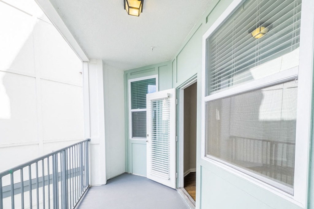 a view of a hallway with a door and a balcony at Linden on the GreeneWay, Orlando, 32824